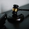 pexels-photo-5668473-5668473 Close-up of a wooden gavel on a desk, symbolizing justice and legal authority.
