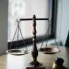 pexels-photo-5669602-5669602 Decorative judgement scale and gavel placed on desk in light lawyer office against window